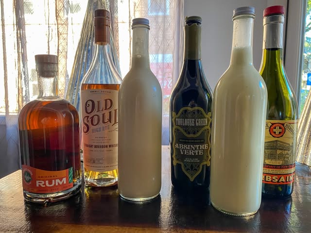 A lineup of bottles in the window light at Vestige